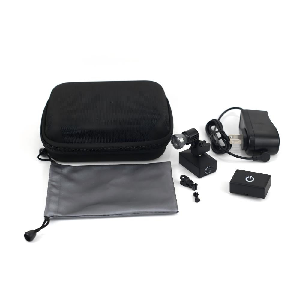 A comprehensive flat-lay view displaying the complete package contents of the Oradenix® wireless surgical LED headlight system. The professional kit includes a premium black protective EVA carrying case, a sleek grey microfiber storage pouch, the main articulated LED lamp unit with an attached HapticSense™ touch-control battery, a second quick-swap lithium battery unit for uninterrupted workflow, a rapid-charge power adapter, and custom mounting clips. This complete dental headlight set provides everything