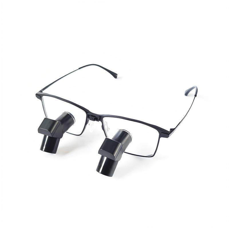 Oradenix premium ergonomic TTL dental loupes featuring a black aerospace titanium frame and deflected Keplerian optical barrels. The design allows dentists to maintain an upright, neutral cervical posture. Displayed on a clean white background.