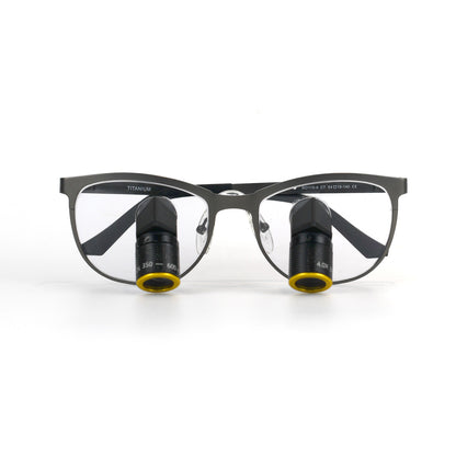 Product photograph of Oradenix Ergo TTL Ti Vario dental loupes on a white background, featuring a full-frame gray titanium frame with 'TITANIUM' marked on the temple. The integrated lenses show specific markings: '350 - 600' on the left lens for variable working distance and '4.0X' on the right lens for magnification. This 4.0X Vario system offers professional ergonomic clarity for dentists.