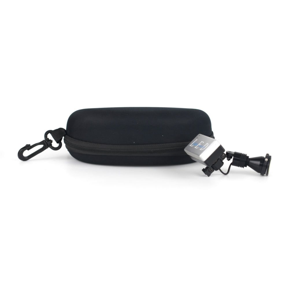 A product image displaying the Oradenix ProLite wireless surgical LED headlight resting next to its included sturdy black protective travel case. The zippered hard-shell case features a convenient carabiner clip, highlighting the portability, safe storage, and travel-friendly design of this premium dental illumination system.