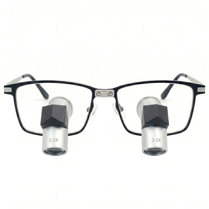 Front view of Oradenix premium TTL loupes featuring elegant silver-white metal lens barrels with 3.5x magnification marking, integrated into a sleek black and silver aerospace-grade titanium frame isolated on a pure white background. Designed for ergonomic posture and high-precision professional laboratory work.
